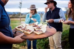 Brisbane Valley Farm Direct person serving food outdoors