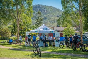 Cyclists gathered around tent at Brisbane Valley Rail Trail
