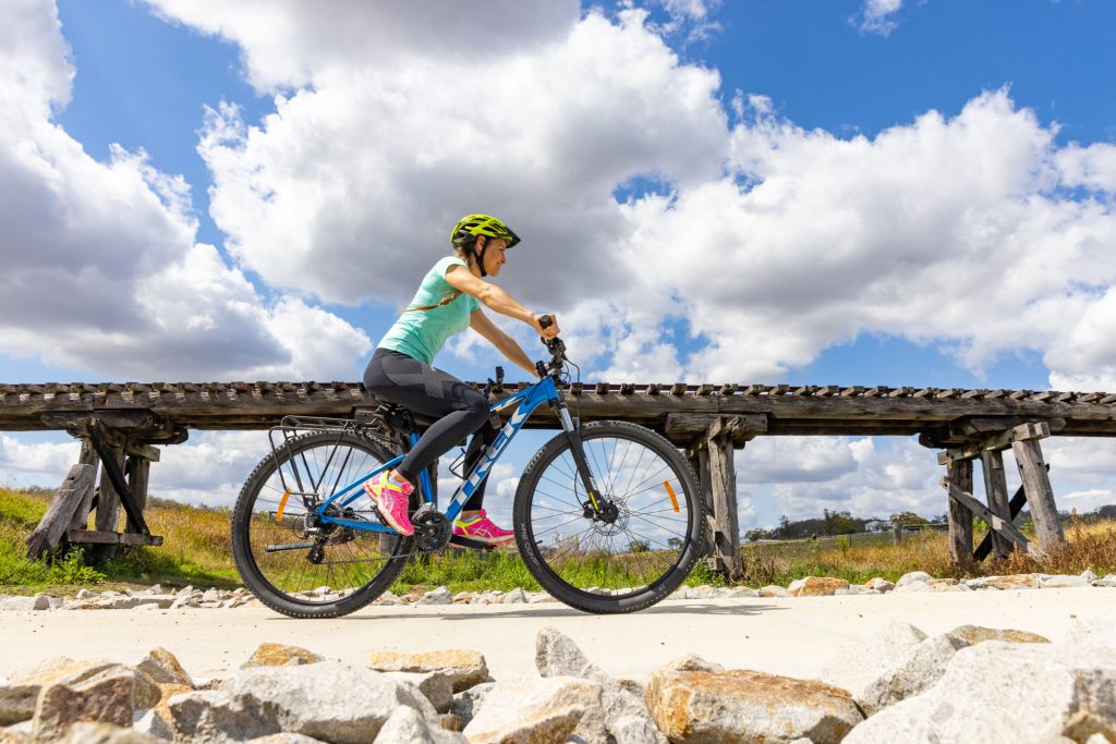 A woman rides a bicycle on the Brisbane Valley Rail Trail