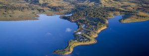 Aerial View of NRMA Lake Somerset Holiday Park and surround landscape and Lake Somerset. The land is jutting out into the lake.