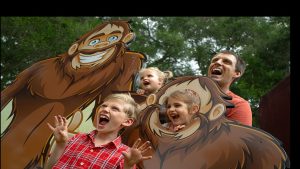 Family portrait with Dad and three kids infront of the Yowie (Australia's Bigfoot) photo board.