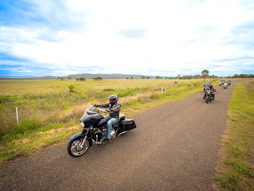 Motorcyclists riding on a country road.