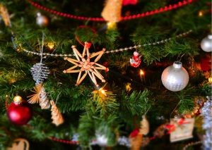 Christmas decorations hanging on a christmas tree.
