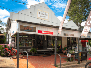Front view of the Linville Store and Cafe, with people sitting out the front
