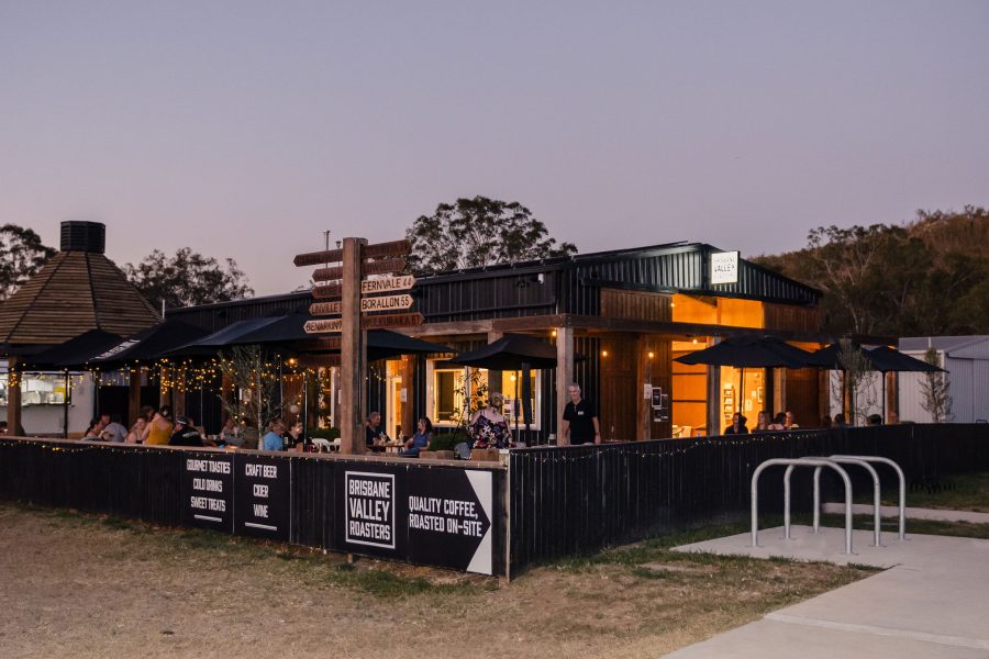 Outside the Brisbane Valley Roasters building with outdoor seating at dusk.