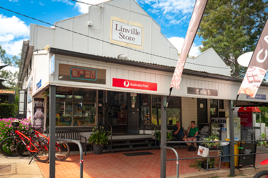 Front view of the Linville Store and Cafe, with people sitting out the front