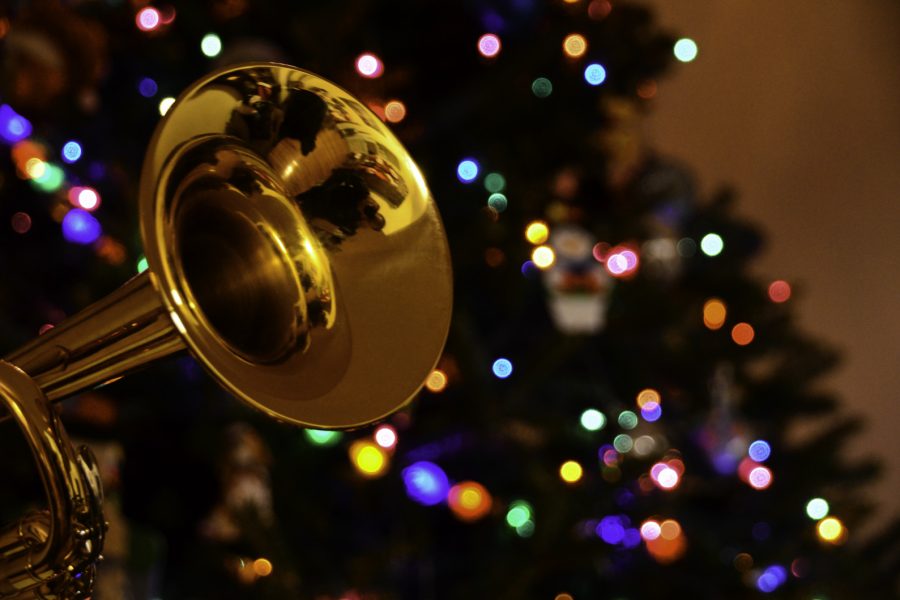 Photo of a trumpet with a lit up Christmas tree in the background