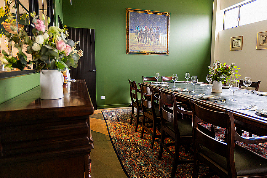 Splityard Social Function room, with dinning tables and green walls