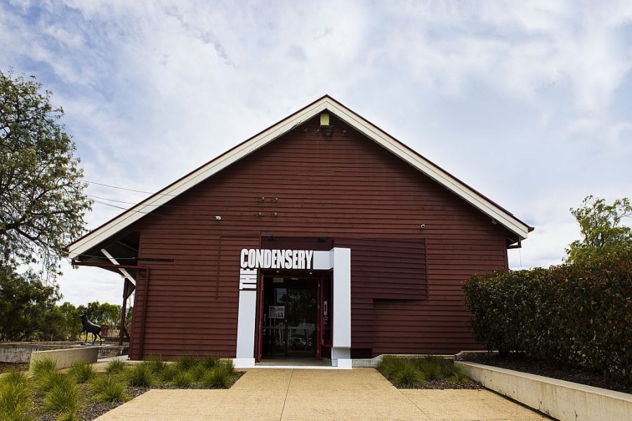 The Condensery | Somerset Regional Art Gallery building entrance. A maroon coloured building with the white The Condensery wording around the door way in bold letters.